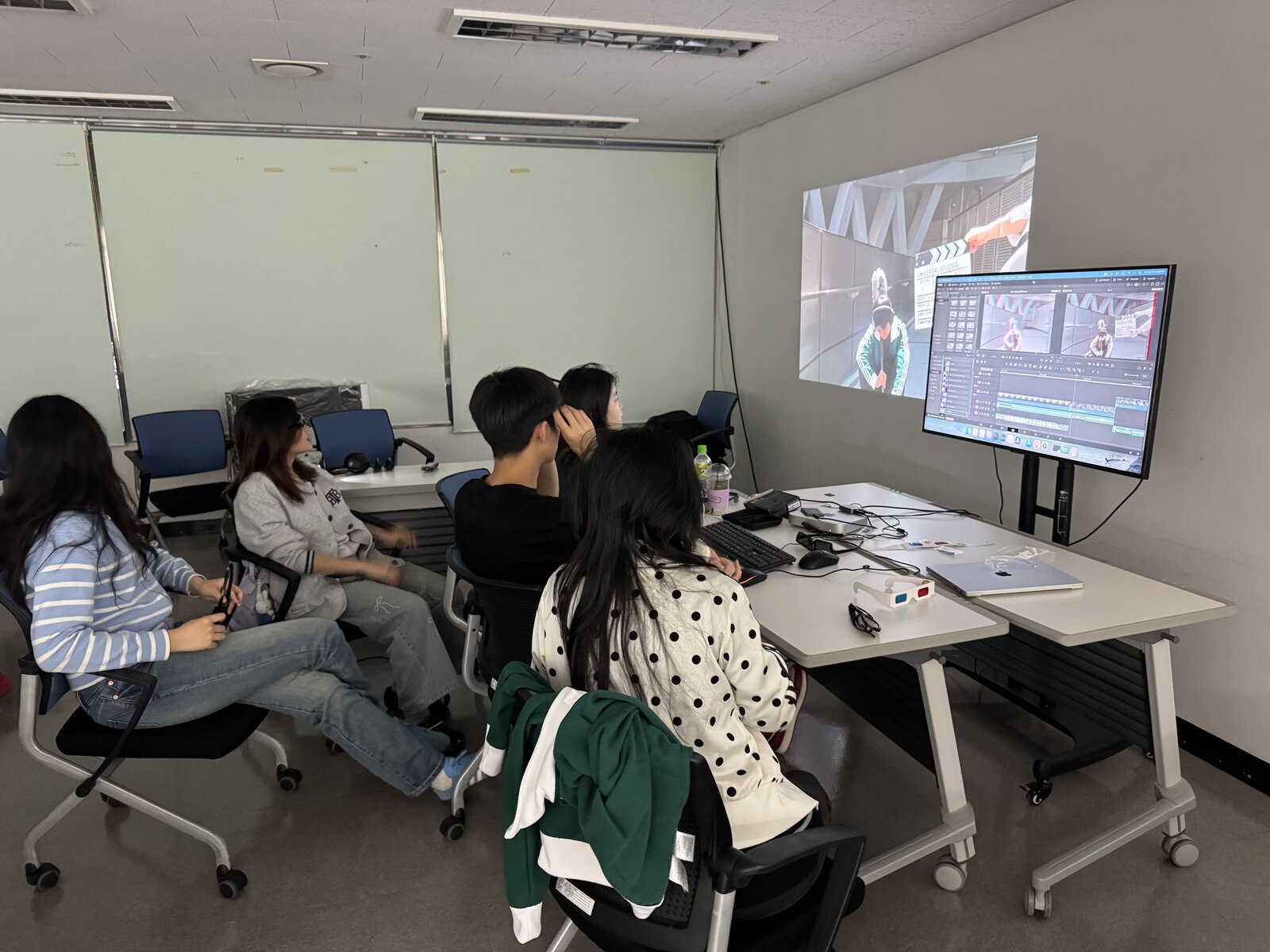 Students viewing a projected image beside the DaVinci Resolve monitor