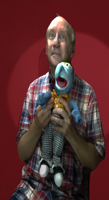 Photogrammetry self-portrait of Alaric Hamacher holding a puppet against a dark red background.